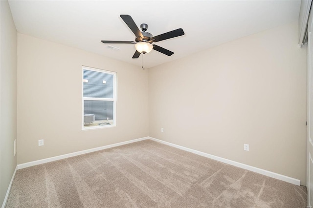 spare room with light colored carpet and ceiling fan