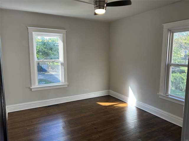 empty room featuring ceiling fan and dark hardwood / wood-style flooring