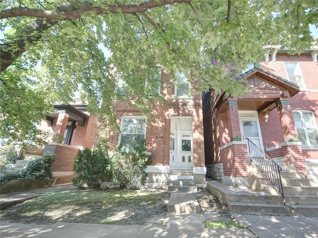 view of front of property with entry steps and brick siding