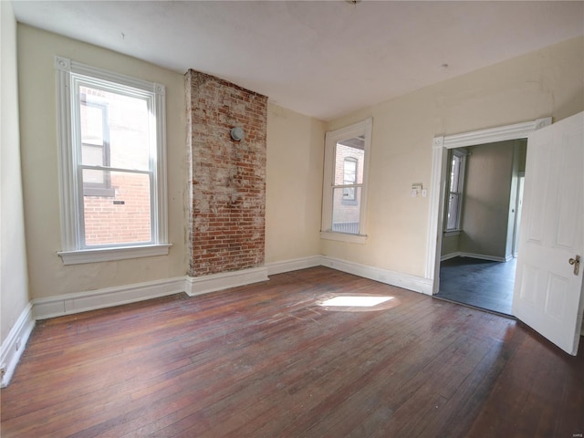 empty room with dark hardwood / wood-style flooring