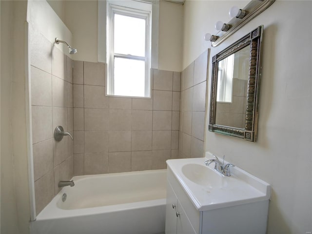 bathroom featuring tiled shower / bath combo and vanity