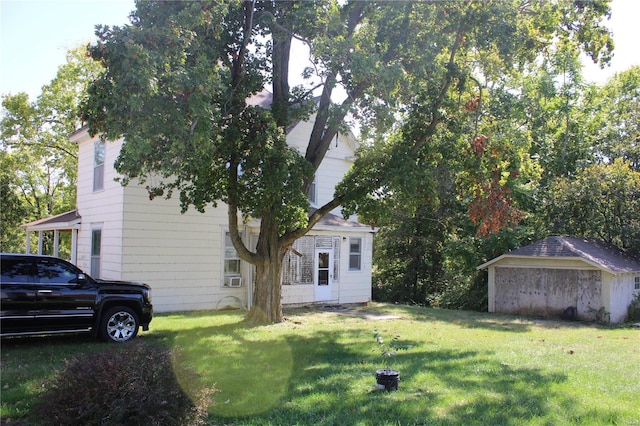 view of home's exterior featuring a lawn and a storage shed