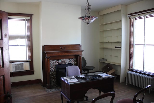 office with cooling unit, dark wood-type flooring, and radiator heating unit