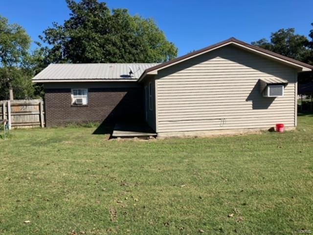 view of property exterior featuring a lawn