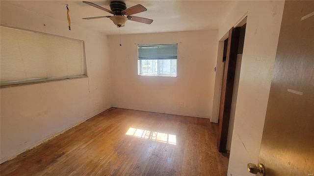 spare room with ceiling fan and light wood-type flooring