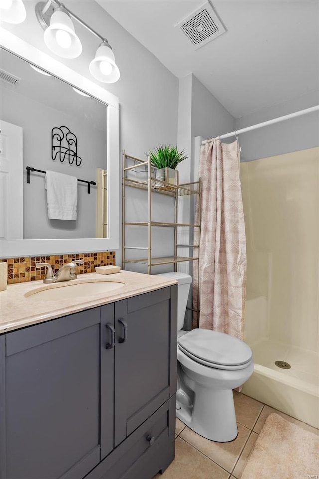 bathroom featuring tasteful backsplash, a shower with curtain, vanity, toilet, and tile patterned floors