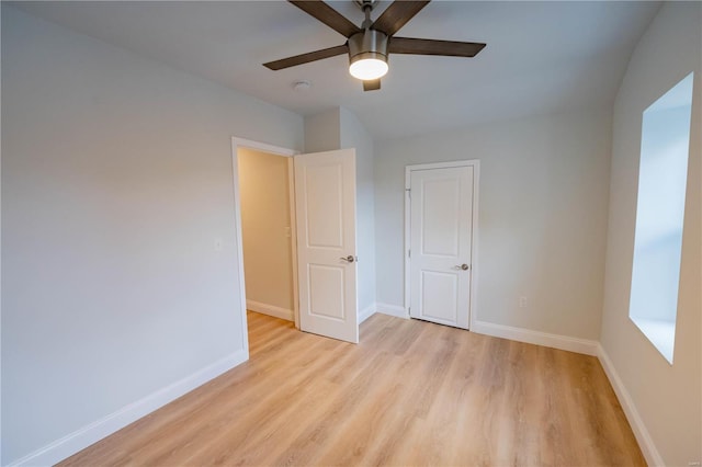 spare room with light wood-type flooring and ceiling fan