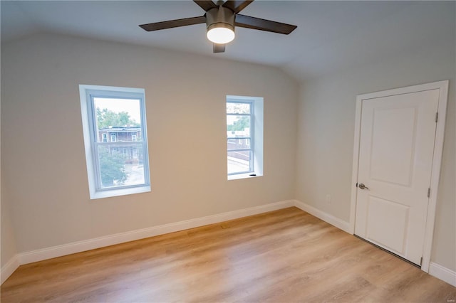 empty room with light wood-type flooring, lofted ceiling, and ceiling fan