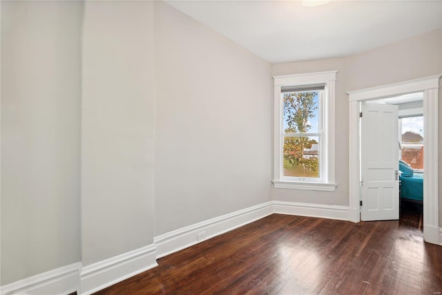 spare room featuring dark hardwood / wood-style flooring