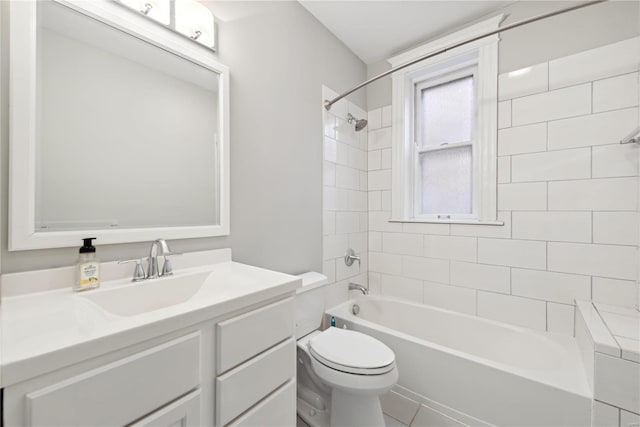 full bathroom with tiled shower / bath combo, tile patterned floors, vanity, and toilet