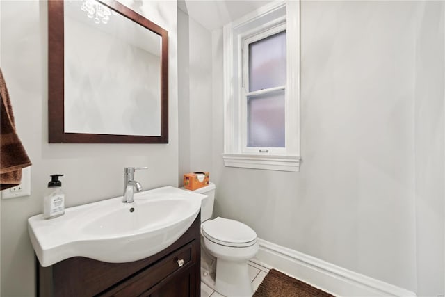 bathroom with vanity, toilet, and tile patterned floors