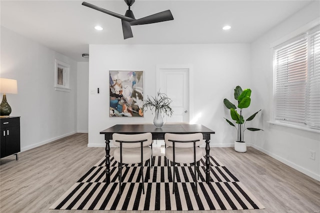 dining space with light hardwood / wood-style floors and ceiling fan