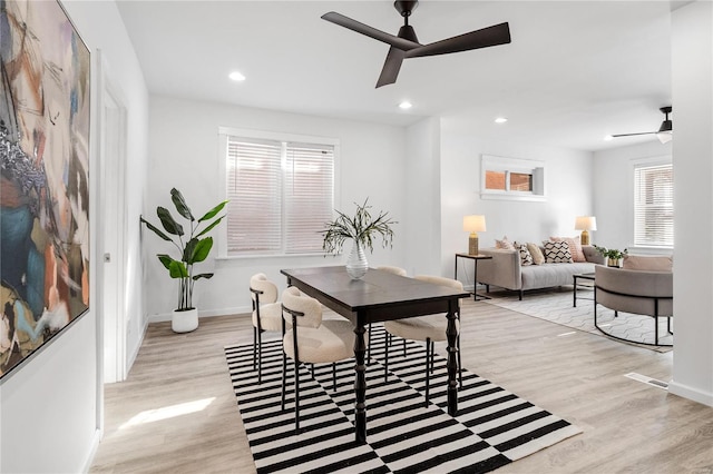 dining room with ceiling fan and light hardwood / wood-style flooring