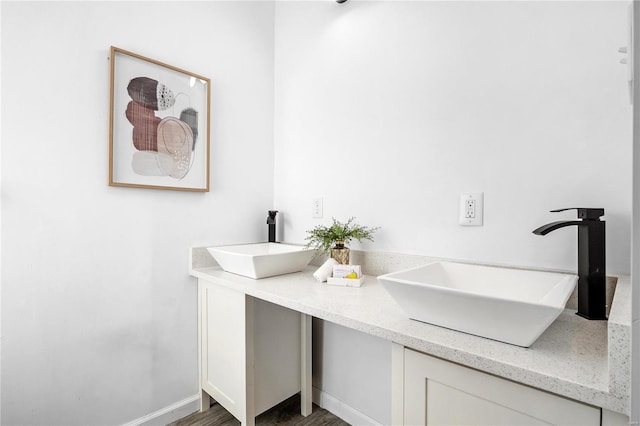 bathroom with wood-type flooring and vanity