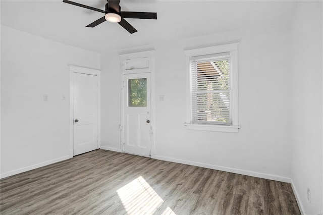 unfurnished room featuring ceiling fan and hardwood / wood-style floors