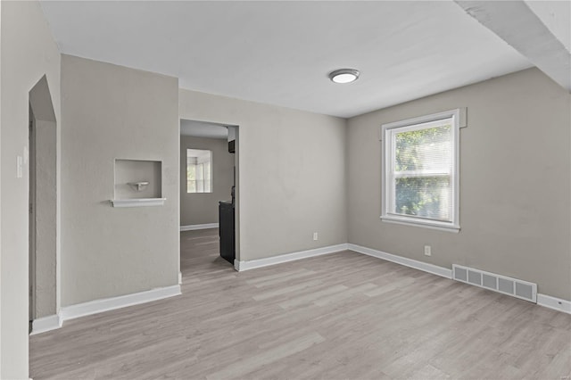 spare room featuring light wood-type flooring