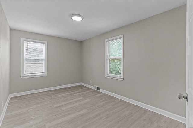 spare room with light hardwood / wood-style flooring