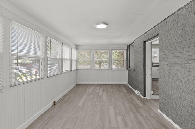 unfurnished sunroom featuring plenty of natural light