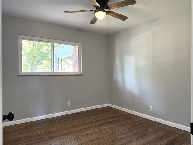 spare room with ceiling fan and dark wood-type flooring