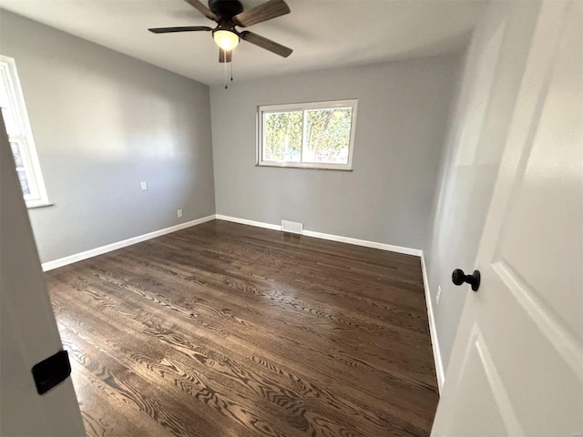 empty room featuring ceiling fan and dark wood-type flooring