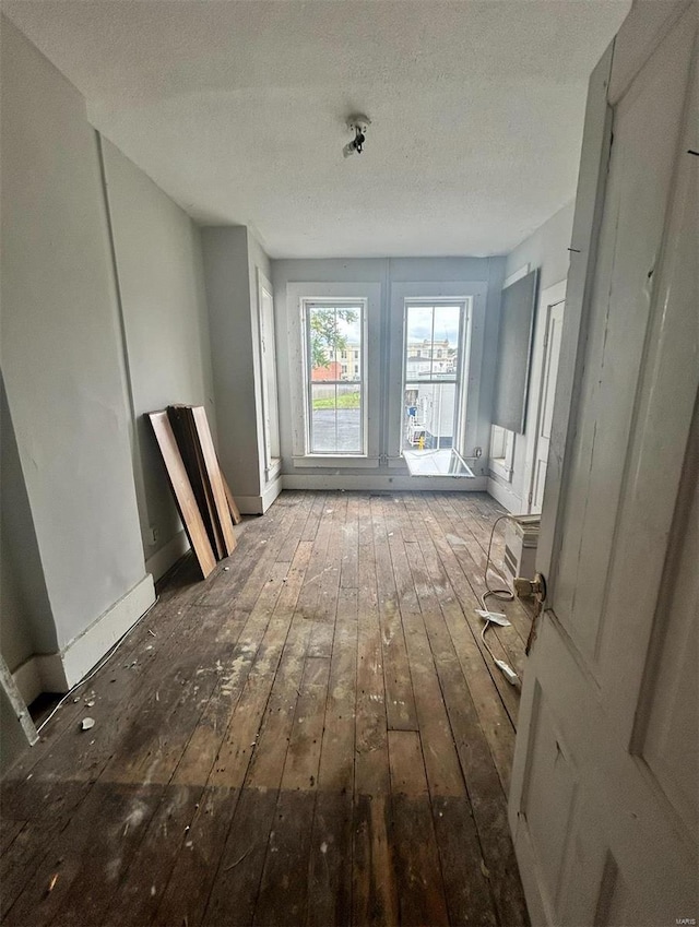 miscellaneous room featuring hardwood / wood-style flooring and a textured ceiling