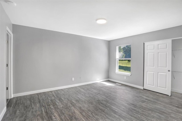 spare room with dark hardwood / wood-style floors