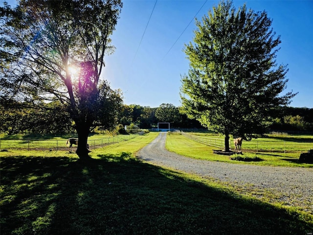 view of home's community featuring fence