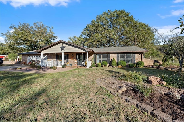 single story home with brick siding, a porch, an attached garage, and a front lawn