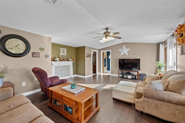 living room with a textured ceiling, baseboards, a ceiling fan, and dark wood finished floors