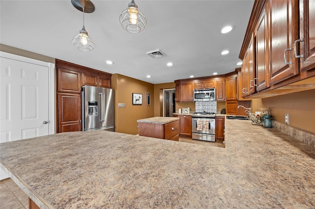 kitchen with a center island, recessed lighting, visible vents, and stainless steel appliances