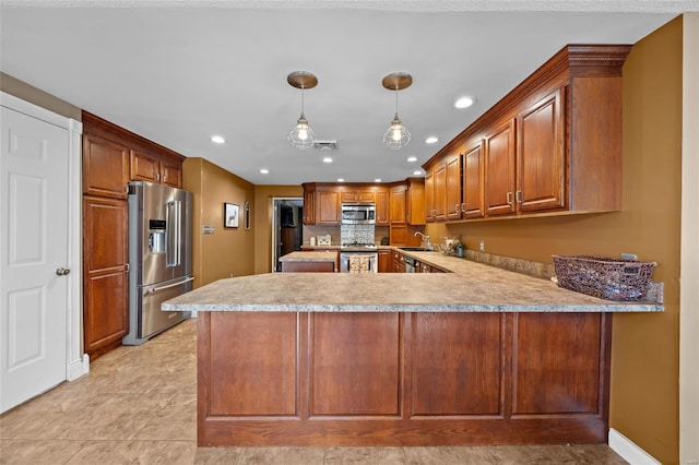kitchen featuring recessed lighting, a peninsula, light countertops, appliances with stainless steel finishes, and a sink