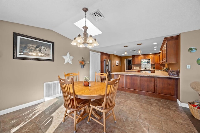 dining space with visible vents, baseboards, an inviting chandelier, and vaulted ceiling