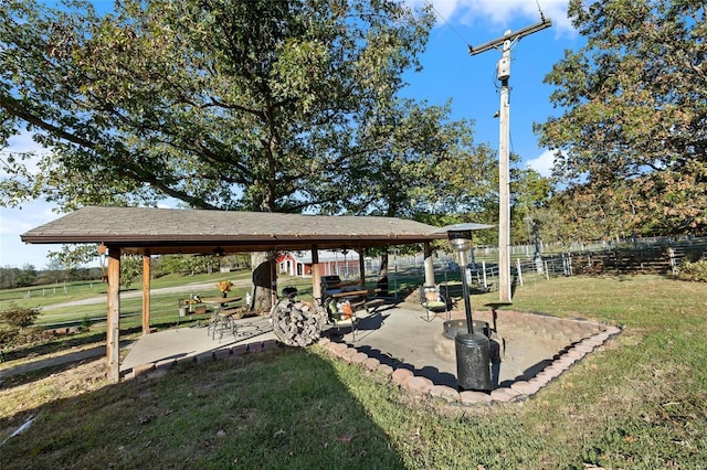 surrounding community featuring a yard, a patio area, and fence
