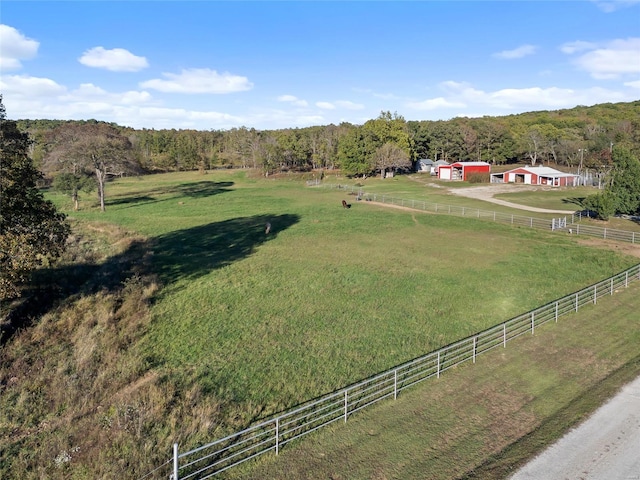 birds eye view of property featuring a forest view and a rural view