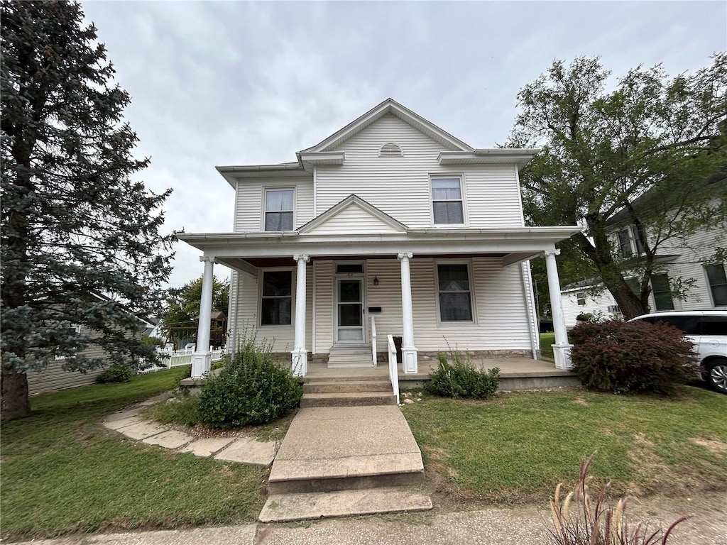 view of front of house featuring a front lawn and a porch