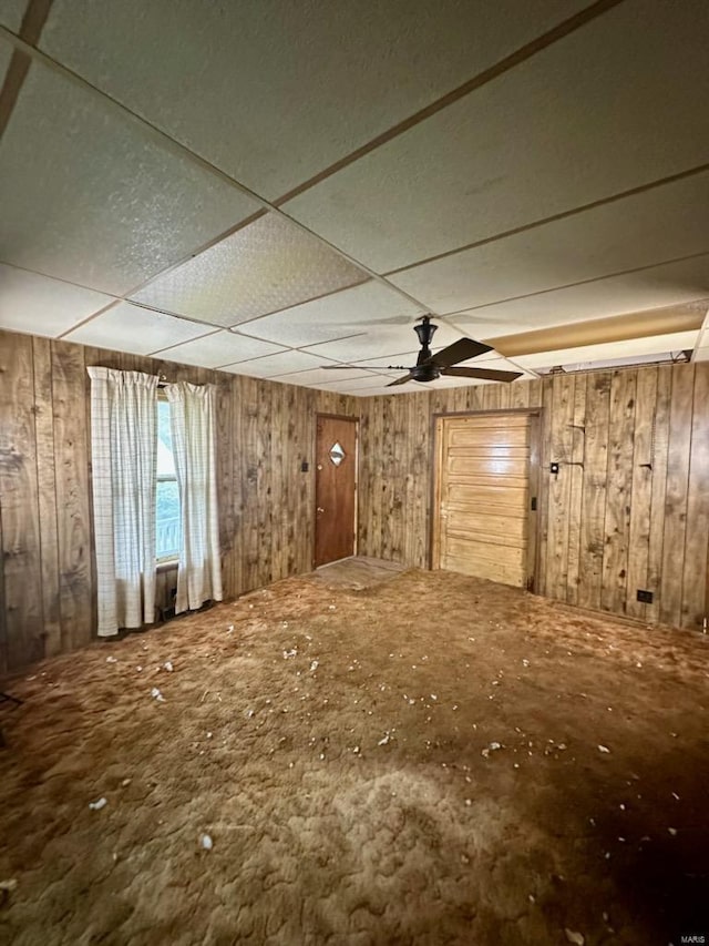 interior space with a paneled ceiling and ceiling fan