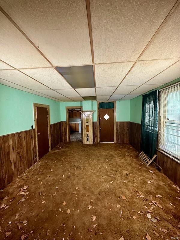 miscellaneous room featuring wooden walls and a paneled ceiling