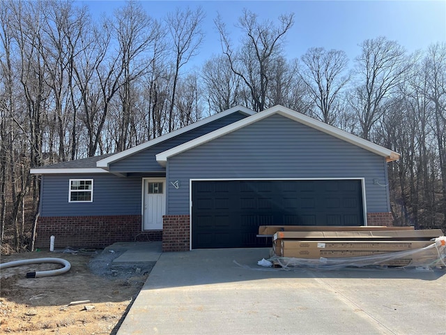 view of front of home with concrete driveway and brick siding