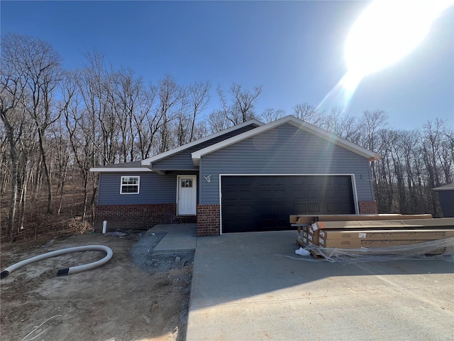 view of front of home featuring brick siding, concrete driveway, and an attached garage