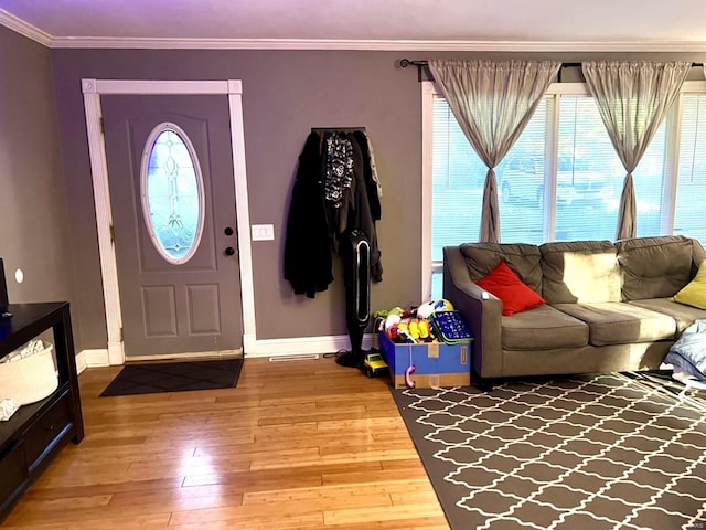 entryway featuring ornamental molding and hardwood / wood-style flooring