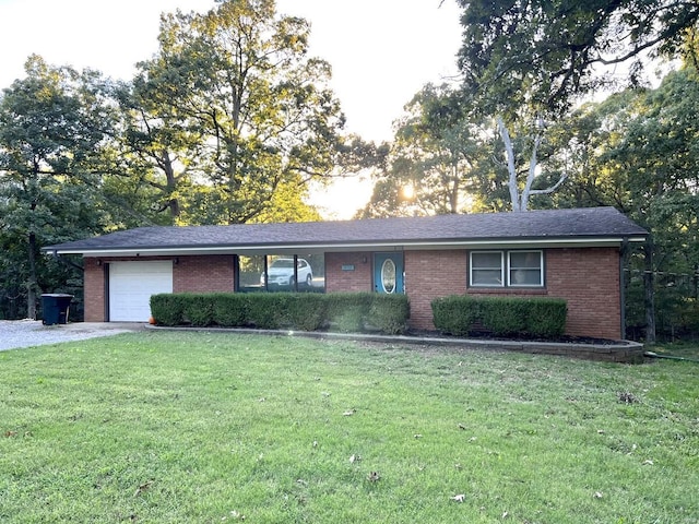 single story home with a front yard and a garage