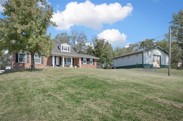 view of front of property with an outdoor structure and a front lawn