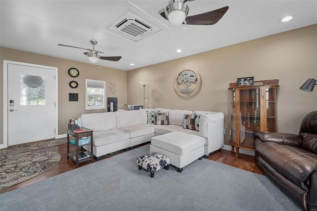 living room with ceiling fan and dark hardwood / wood-style floors