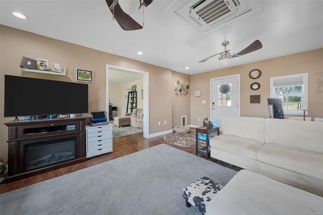 living room featuring ceiling fan and dark hardwood / wood-style flooring