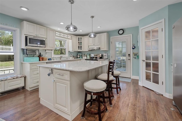 kitchen with plenty of natural light, appliances with stainless steel finishes, and a center island