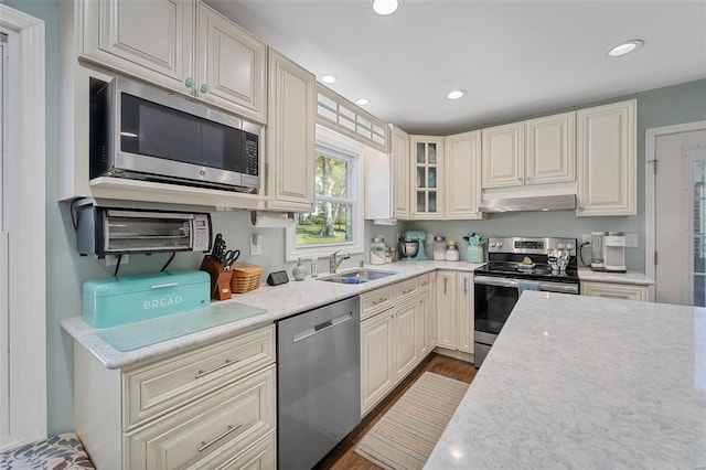 kitchen featuring appliances with stainless steel finishes, dark wood-type flooring, and sink