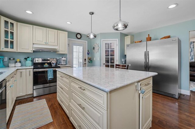 kitchen featuring pendant lighting, appliances with stainless steel finishes, dark wood-type flooring, and a kitchen island