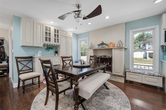 dining space with ceiling fan and dark hardwood / wood-style floors