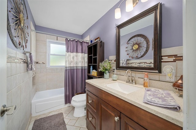 full bathroom with shower / tub combo with curtain, tile patterned flooring, vanity, and toilet