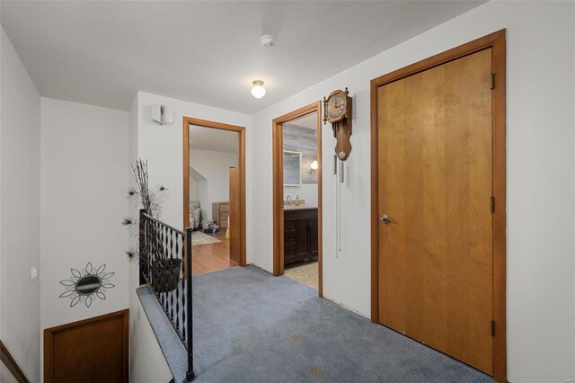 hallway with light colored carpet